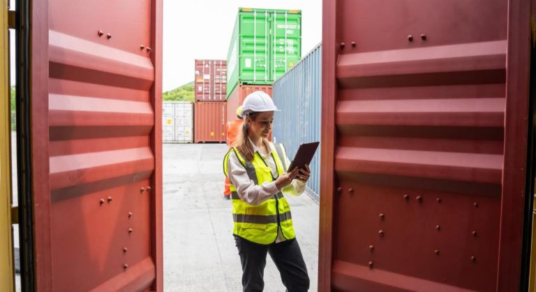 Woman Manager Using Tablet for checking code of Cargo container